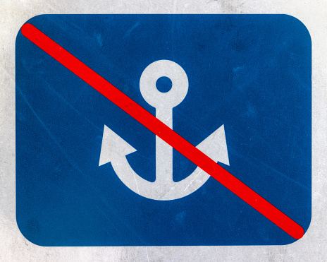 White icon of ship anchor with red diagonal bar on blue rectangular background