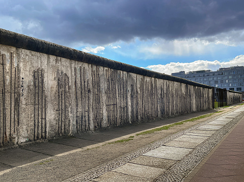 close up of a portion of the remnants of the Berlin wall, a re-enforced concrete barrier, as seen from the West Berlin side, Germany