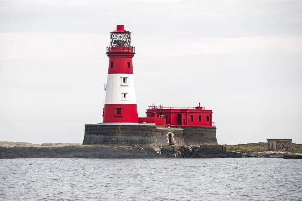 istock a large white and red lighthouse with a tower on top of it 1483633483