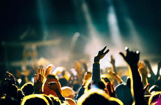 De-focused concert stage with laser lights and beams.