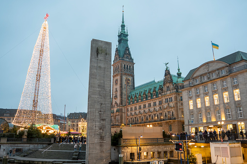 German Christmas market on Hamburg main square on December 4, 2022. Christmas tree by Alser channel.