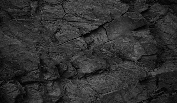 istock Black white rock texture. Dark gray stone granite background. Cracked rough mountain surface. 1483647938