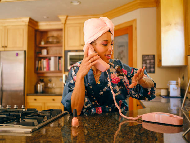 A woman at home in a kitchen with a 1970’s/1980’s vintage feel.
