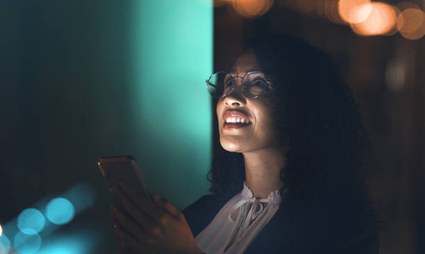 istock Business, black woman and phone at night thinking idea for communication network connection. Entrepreneur person in dark office for social media ux, networking or ai mobile app marketing mockup 1483649936