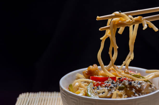 istock Bamboo sticks and Chinese noodles with fish and vegetables 1483651033