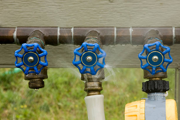 water leak leaking water faucet sends a spray mist  of wasted water into the air baby bib stock pictures, royalty-free photos & images