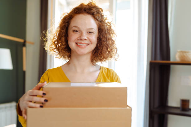 istock Female customer holding cardboard boxes at home 1483656992