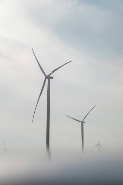 istock Wind turbines producing clean energy hidden in dense fog 1483657155