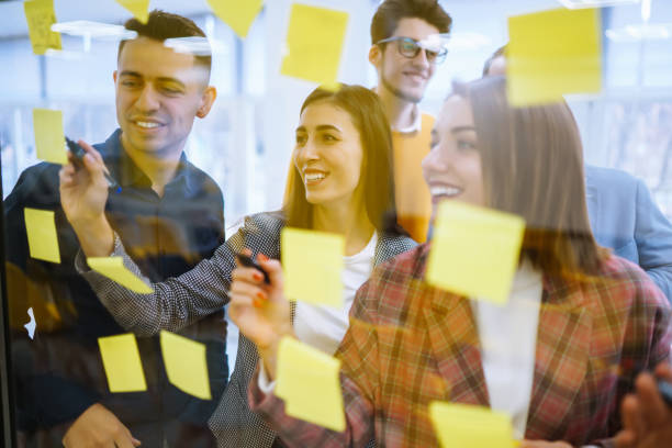 istock Modern group of people sharing ideas concept with paper note writing strategy in office. 1483657175