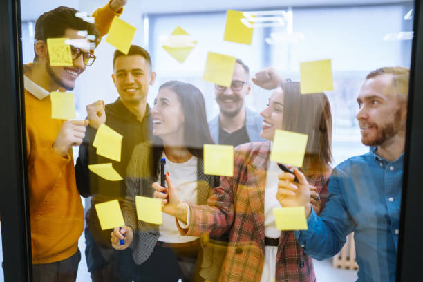 istock Modern group of people sharing ideas concept with paper note writing strategy in office. 1483657180