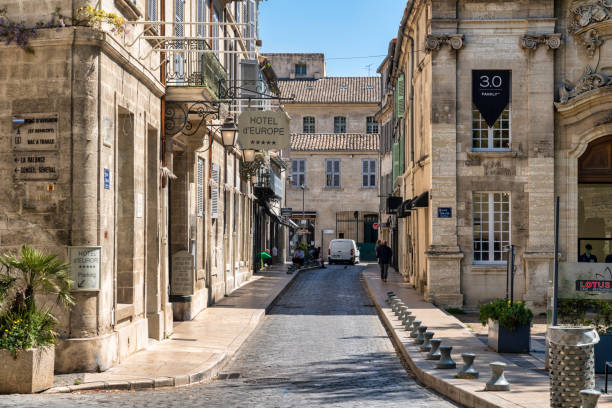 April 20, 2023: This photo captures the timeless beauty of Avignon, a charming village located in the heart of Provence, France. The image shows a picturesque street lined with historic buildings, colorful shutters, and balconies. This photograph is perfect for travel and lifestyle publications seeking to showcase the unique beauty and cultural heritage of France. It can also be used as a decorative piece, evoking the romance and charm of French village life.