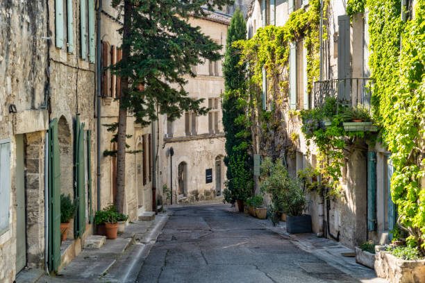April 20, 2023: This photo captures the timeless beauty of Avignon, a charming village located in the heart of Provence, France. The image shows a picturesque street lined with historic buildings, colorful shutters, and balconies. This photograph is perfect for travel and lifestyle publications seeking to showcase the unique beauty and cultural heritage of France. It can also be used as a decorative piece, evoking the romance and charm of French village life.