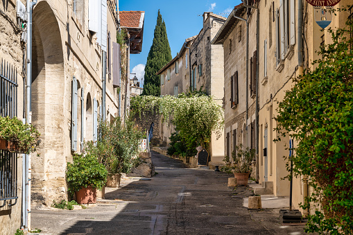 April 20, 2023: This photo captures the timeless beauty of Avignon, a charming village located in the heart of Provence, France. The image shows a picturesque street lined with historic buildings, colorful shutters, and balconies. This photograph is perfect for travel and lifestyle publications seeking to showcase the unique beauty and cultural heritage of France. It can also be used as a decorative piece, evoking the romance and charm of French village life.