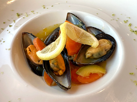An appetizer of steamed mussels and vegetables
