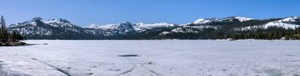 istock Caples Lake - A panoramic Spring view of snow covered Caples Lake and its surrounding mountains. Kirkwood, California, USA. 1483663011