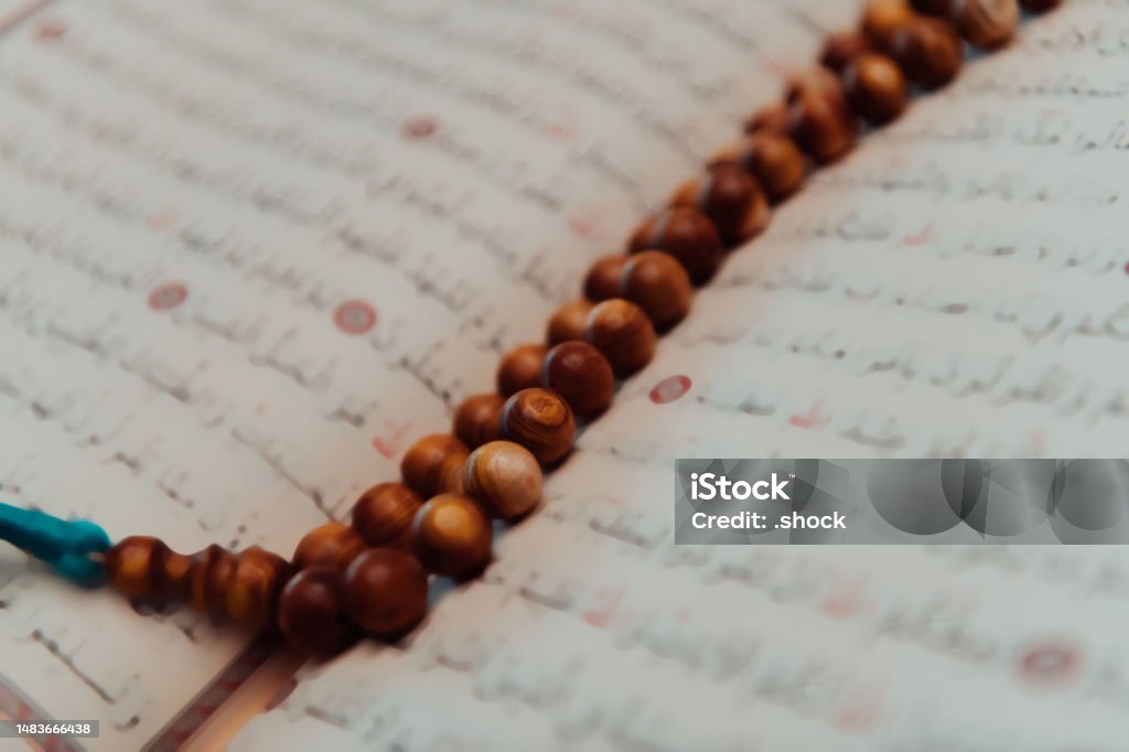 Photo of the holy Islamic book of the Qoran in a modern mosque Photo of the holy Islamic book of the Qoran in a modern mosque. Allah Stock Photo