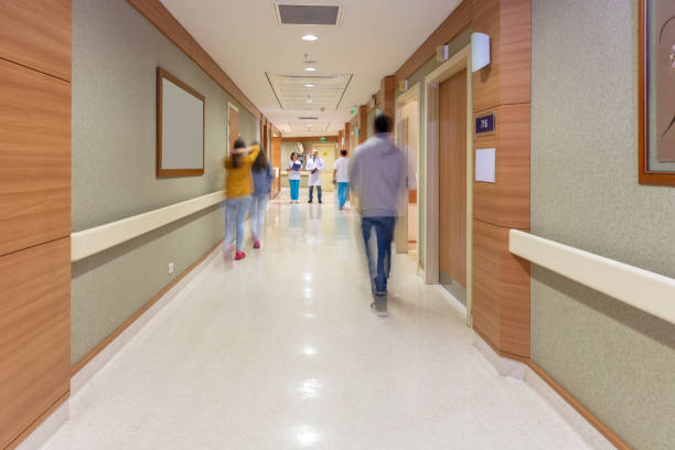 A group of doctors stands around the patient's bed. The student is sitting on the bed and the interns are examining him. Discussion of the treatment plan. Medicine and health. The scene is serious