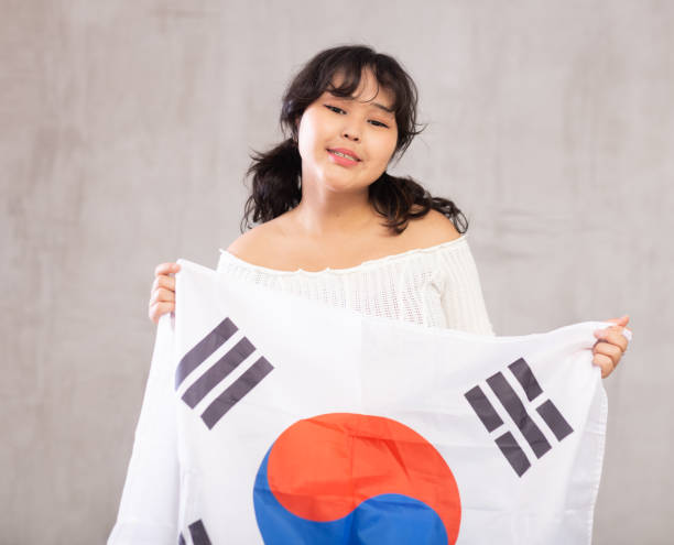 istock Smiling young girl holding South Korea flag 1483674732
