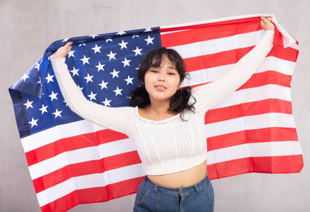 istock Smiling young girl holding USA flag 1483674739