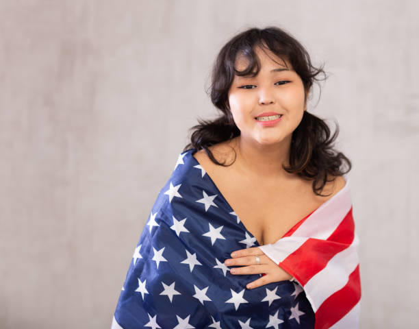 Smiling young girl wrapped in USA flag