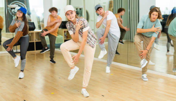 Group of teenagers rehearsing contemporary dance indoors Young boys and girls performing contemporary dance in studio. contemporary dance stock pictures, royalty-free photos & images