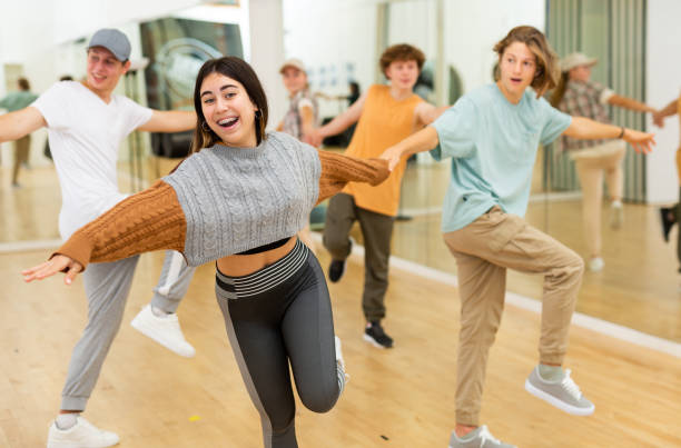 istock Teens performing swing dance in ballroom 1483674796