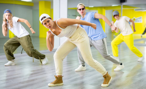 istock Teenage girl having group dance training in studio, performing dynamic elements 1483674943