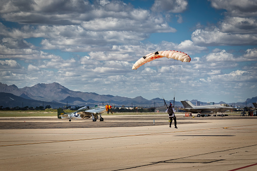 Tucson, Arizona, USA - March 24, 2023: A parachutist with the Red Bull Air Force lands at the 2023 Thunder and Lightning Over Arizona airshow.