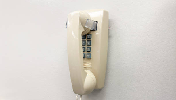 istock old-school payphone with a dangling line can symbolize nostalgia for a time when communication was simpler and more tangible. It can also represent a sense of connection or disconnection 1483691240