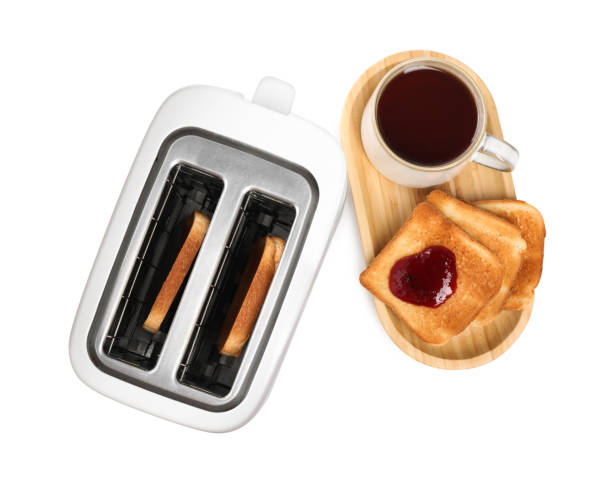 istock Toaster with roasted bread, jam and tea on white background, top view 1483695232