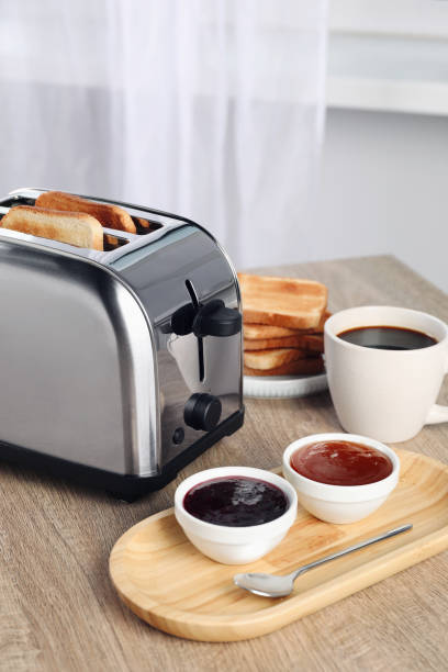 istock Toaster with roasted bread, coffee and jams on wooden table 1483695391