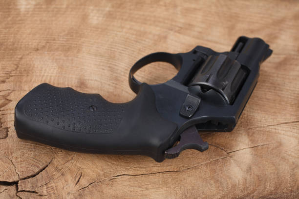 istock Cocked revolver on wooden table 1483695403
