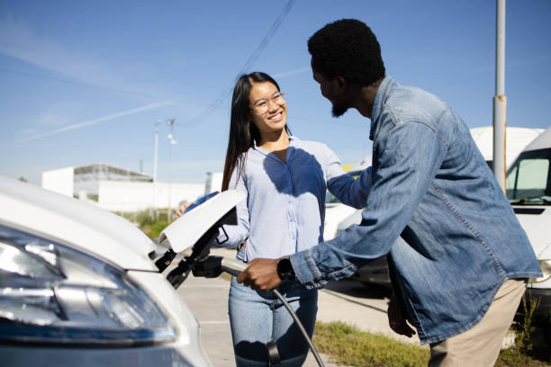 istock Young couple on vacation charging their electric camper 1483700616