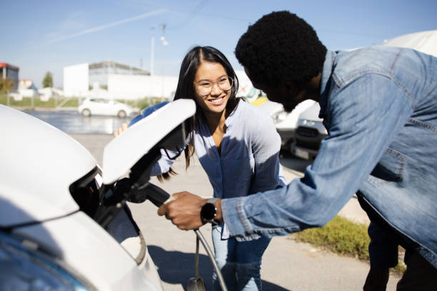 istock Young couple on vacation charging their electric camper 1483700619