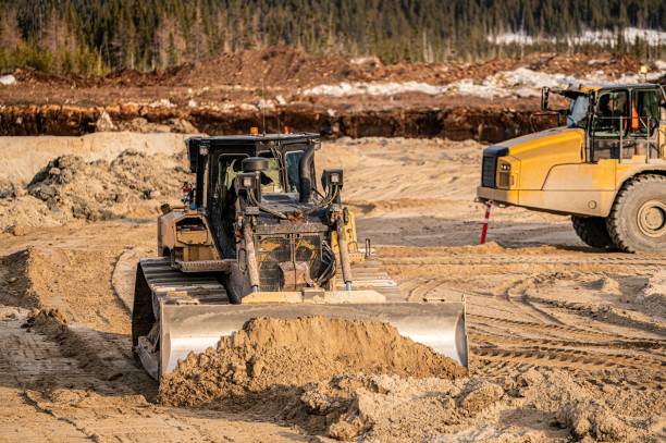 istock Bulldozer pushing sand on the bottom of an excavation 1483701857