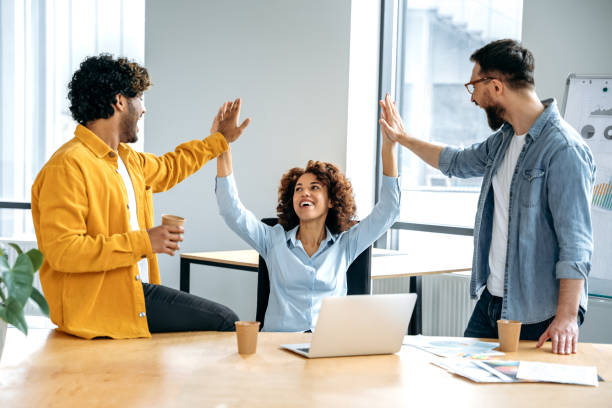 istock Cheerful colleagues, multiracial team, sitting in a creative office, working on a new project, a startup, developing a strategy and deadlines, happy with the result, celebrate success, achievement 1483708307