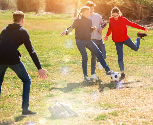 Teenagers play football with excitement Teenagers play street football with excitement 12 17 months stock pictures, royalty-free photos & images