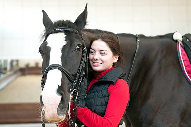 istock young woman with black horse 148371142
