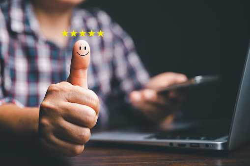 Customer service and Satisfaction concept, Business person are touching the virtual screen on happy Smiley face icon to give satisfaction in service. rating very impressed. customer service feedback.