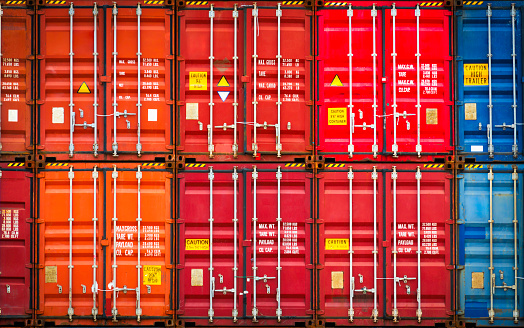 Row of Stacked Colorfull Containers Cargo Shipping. Cargo Container ships, Freight Trucks Import-Export Business. Distribution Warehouse. Handling of Logistic Transportation Industry.