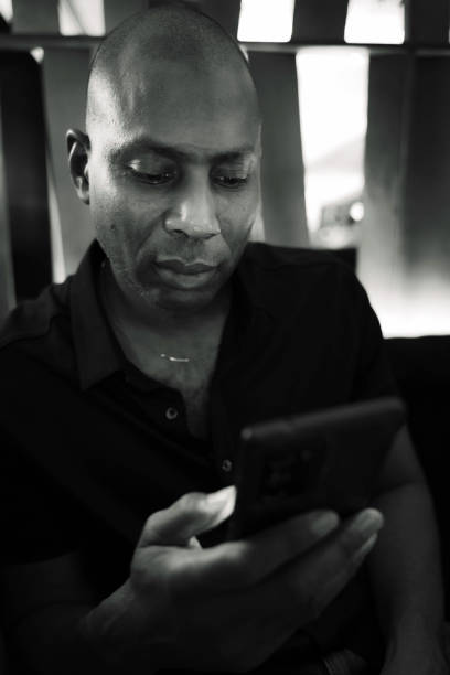 istock A smiling man with a mobile phone in his hand. 1483731630