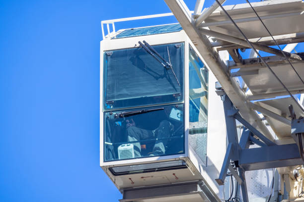 Rotterdam, The Netherlands - September 8, 2013: Gantry harbor crane operator moving two containers on Sep 8, 2013 in Rotterdam, Netherlands. The port is the largest in Europe and facilitate the needs of a hinterland with 40,000,000 consumers.
