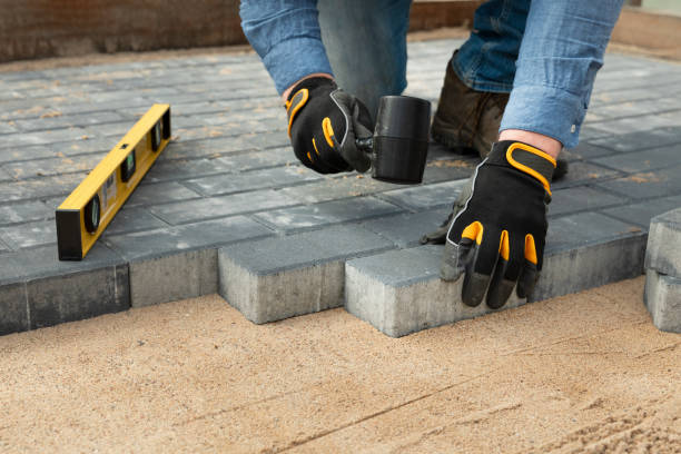 istock Construction worker laying cement pavement on a walkway with gloves and rubber hammer. House improvement. 1483737505