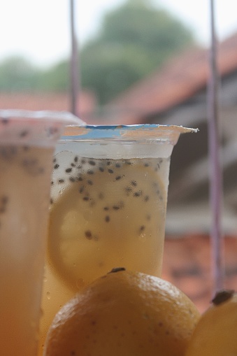 Close Up of Fresh Lemon Iced Tea with basil seeds in a plastic cup