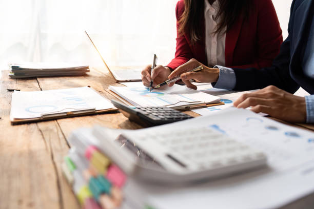 Business team collaboration discussing working analyzing with financial data and marketing growth report graph in team, presentation and brainstorming to strategy planning making profit of company