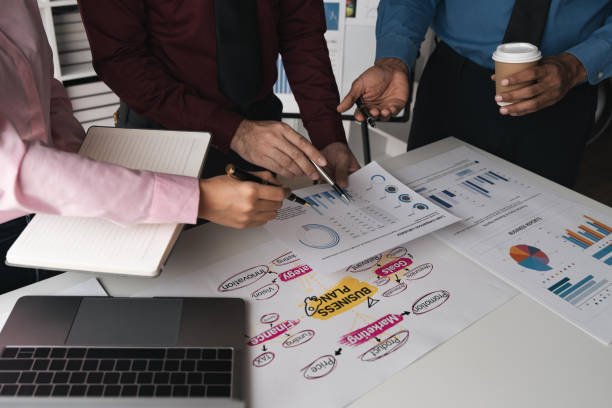 istock Intelligence analysis concept, group of business people brainstorm discussing current finance and economy on company investment laptop at meeting 1483744986