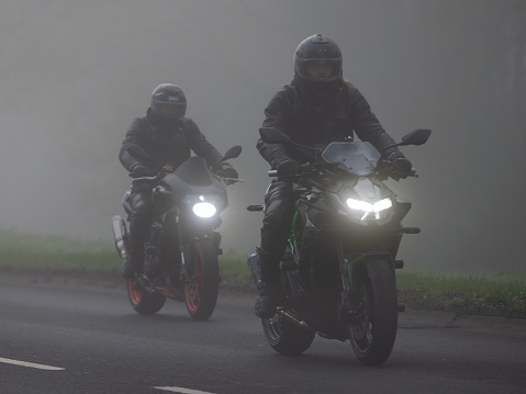 Milton Keynes,Bucks,UK, April 8th 2023. Two motorcycles  driving in the fog on an English country road