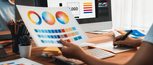 Graphic designer works on computer laptop with digital pen. Scrutinize