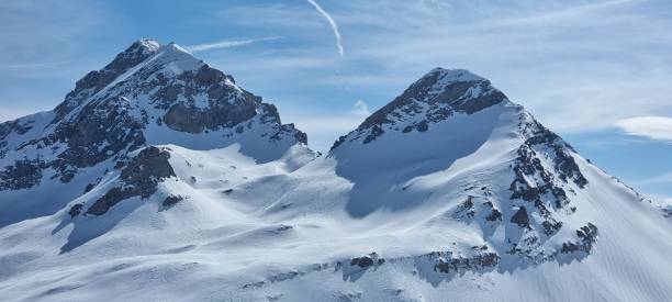 istock Winter scene featuring a snow-covered mountain slope with a bright blue sky in the background 1483749591