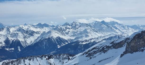 istock Winter scene featuring a snow-covered mountain slope with a bright blue sky in the background 1483749597